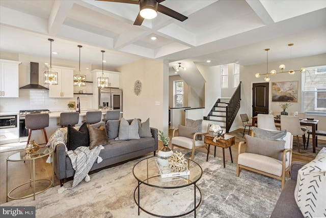 living room featuring coffered ceiling, a ceiling fan, stairs, beamed ceiling, and recessed lighting