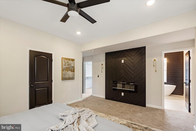 carpeted bedroom with baseboards, recessed lighting, ensuite bathroom, and a ceiling fan