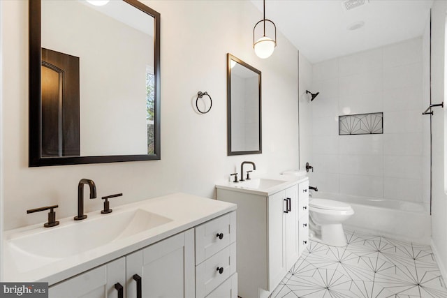 bathroom featuring two vanities, tub / shower combination, and toilet