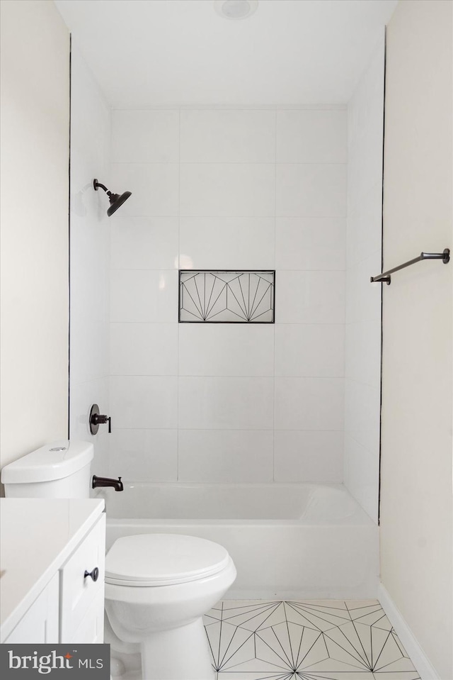 bathroom with toilet, tile patterned floors, vanity, and shower / bathtub combination