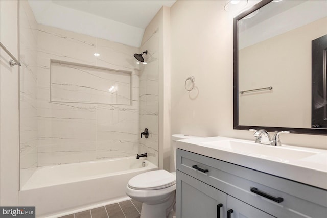 bathroom featuring toilet, vanity, and bathtub / shower combination