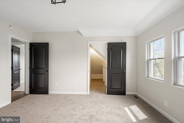 unfurnished bedroom featuring carpet floors and baseboards
