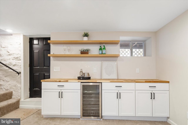indoor wet bar with beverage cooler and stairway