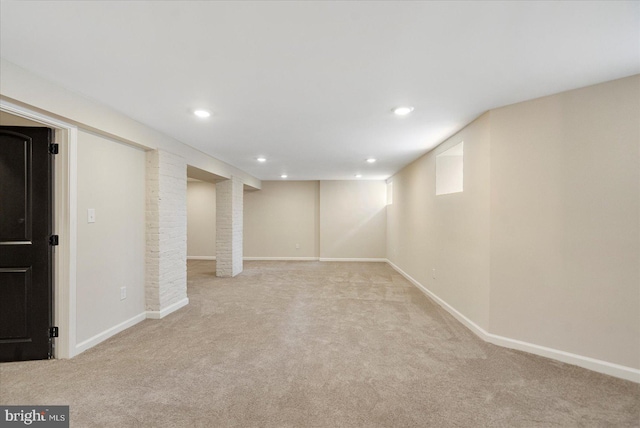 finished below grade area with carpet flooring, recessed lighting, and baseboards
