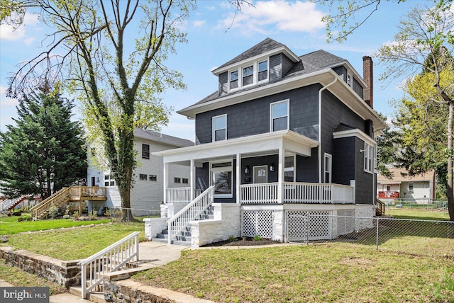 american foursquare style home with stairway, covered porch, a chimney, and roof with shingles