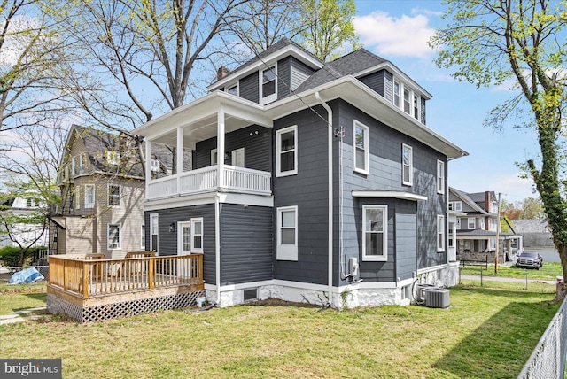 view of side of property featuring a balcony, a chimney, central AC, and a wooden deck