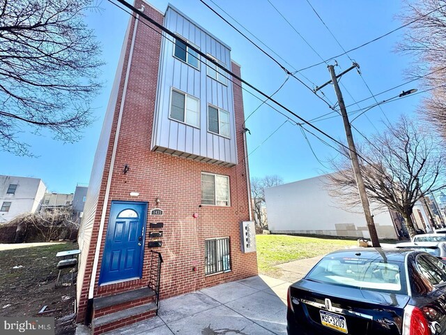 1431 N 17th St, Philadelphia, PA 19121 - view of front of home featuring entry steps, brick siding, and board and batten siding
