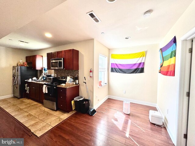 1431 N 17th St, Philadelphia, PA 19121 - kitchen featuring stainless steel appliances, light wood-style floors, decorative backsplash, baseboards, and recessed lighting