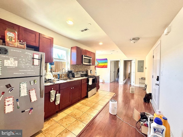1431 N 17th St, Philadelphia, PA 19121 - kitchen with appliances with stainless steel finishes, a sink, light wood-type flooring, light countertops, and electric panel