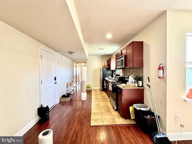 1431 N 17th St, Philadelphia, PA 19121 - kitchen with appliances with stainless steel finishes, light wood-style floors, decorative backsplash, and baseboards