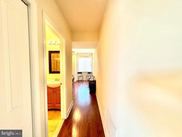 1431 N 17th St, Philadelphia, PA 19121 - corridor with dark wood finished floors, a sink, and baseboards