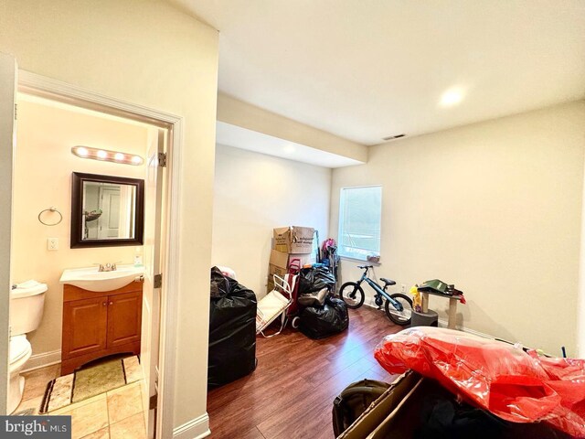 1431 N 17th St, Philadelphia, PA 19121 - bedroom with a sink, wood finished floors, ensuite bath, and recessed lighting