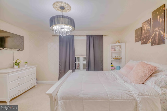 carpeted bedroom with a chandelier