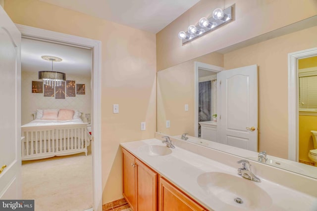bathroom with double vanity and toilet
