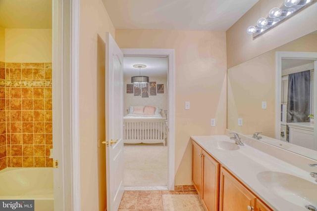 bathroom featuring double vanity, a tub to relax in, and tile patterned floors