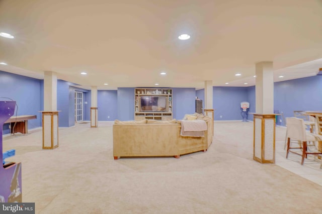 carpeted living area with recessed lighting and baseboards