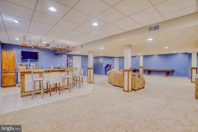 indoor wet bar with light colored carpet, baseboards, a drop ceiling, light tile patterned floors, and recessed lighting