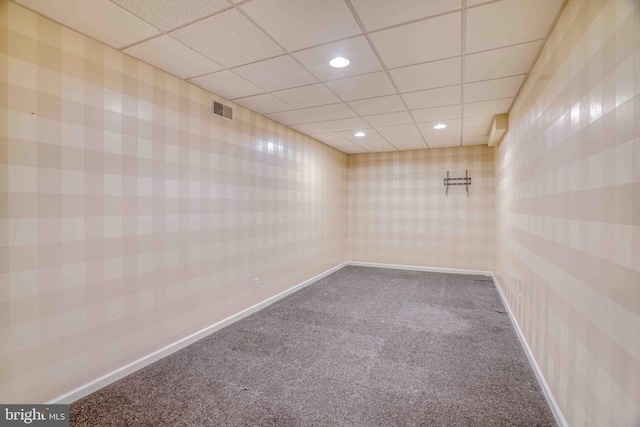 spare room featuring dark carpet, a paneled ceiling, recessed lighting, wallpapered walls, and baseboards