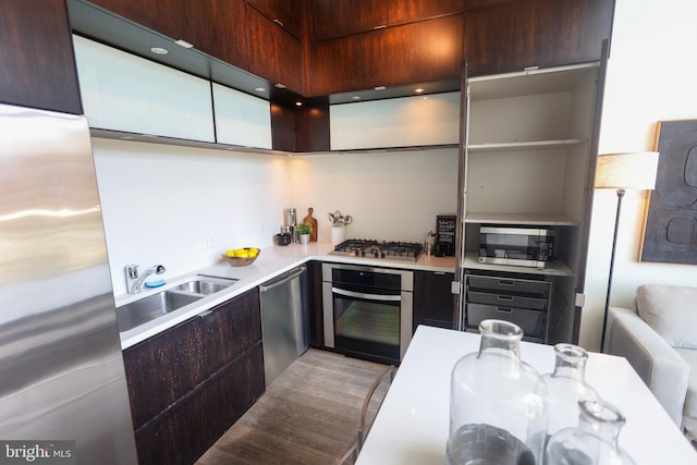 1515 15th St NW Unit 424, Washington, DC 20005 - kitchen featuring stainless steel appliances, light countertops, modern cabinets, dark brown cabinetry, and a sink