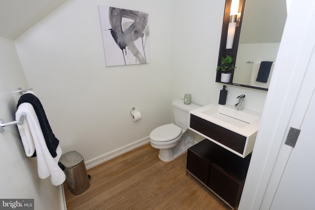 1515 15th St NW Unit 424, Washington, DC 20005 - half bathroom with wood finished floors, toilet, vanity, and baseboards