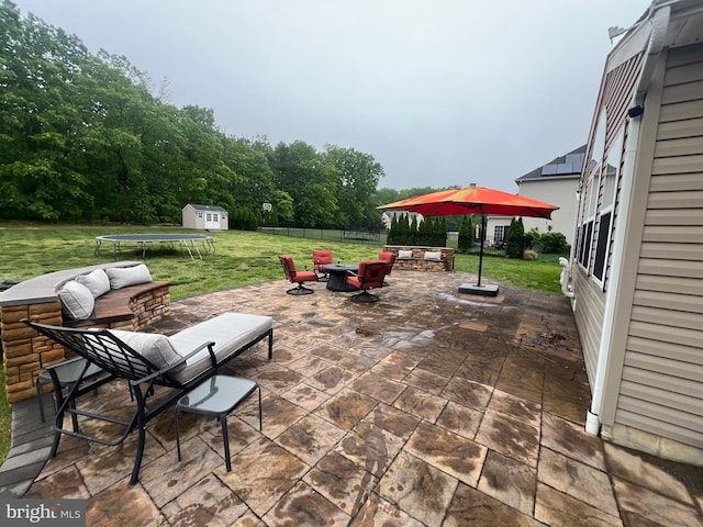 23 Cardinal Ln, Sicklerville, NJ 08081 - view of patio / terrace with a trampoline, a fire pit, an outdoor structure, and a storage shed