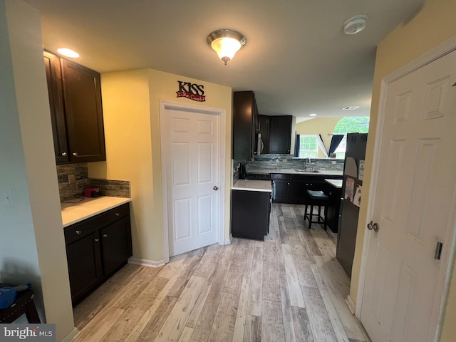 23 Cardinal Ln, Sicklerville, NJ 08081 - kitchen with a sink, light wood-style flooring, tasteful backsplash, and light countertops