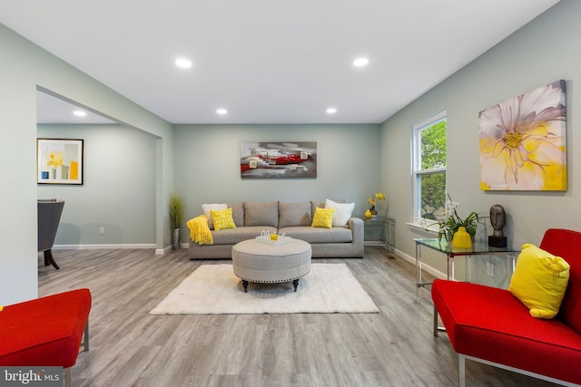 living area with wood finished floors, recessed lighting, and baseboards