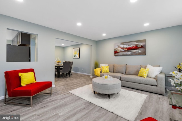 living area with wood finished floors, recessed lighting, and baseboards