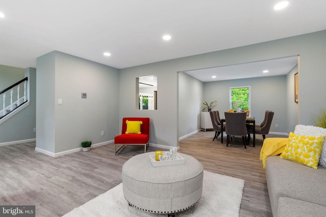 living area with stairway, wood finished floors, recessed lighting, and baseboards
