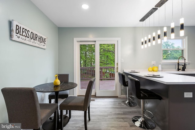 dining area with plenty of natural light, wood finished floors, and recessed lighting