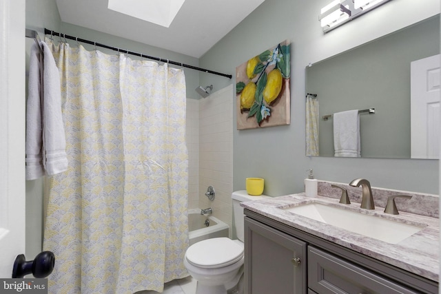bathroom with a skylight, toilet, vanity, and shower / bathtub combination with curtain