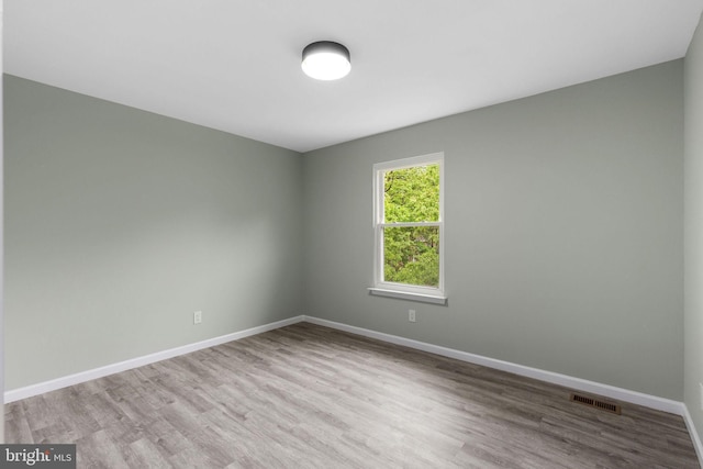 unfurnished room featuring wood finished floors and baseboards