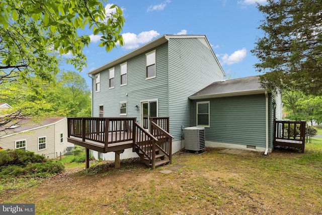 rear view of property featuring central air condition unit, a deck, crawl space, and a yard