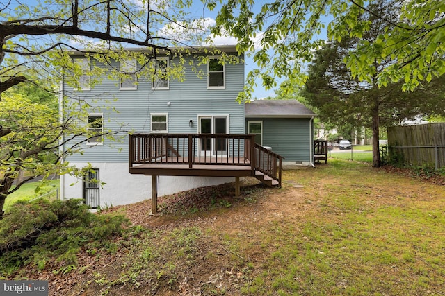 rear view of property featuring a wooden deck