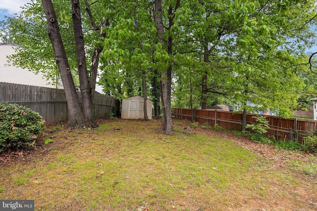 fenced backyard with a storage shed and an outdoor structure