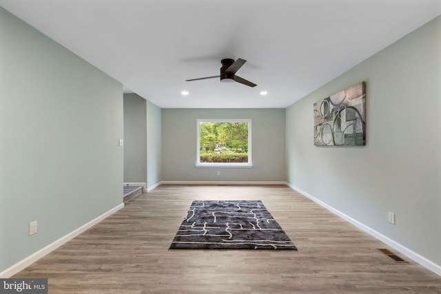 spare room featuring a ceiling fan, wood finished floors, baseboards, and recessed lighting