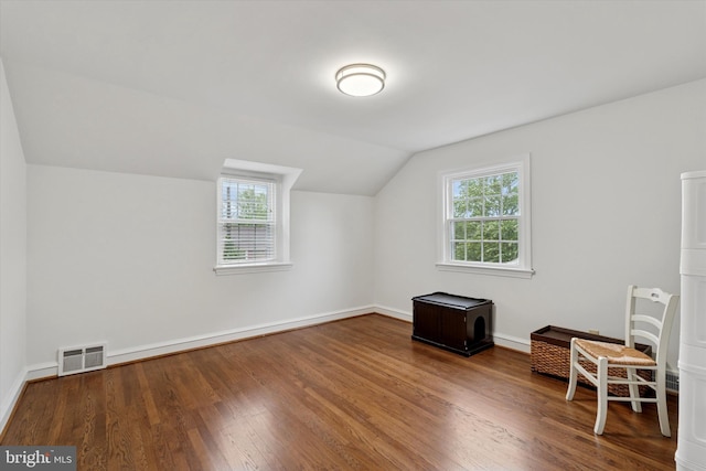 bonus room featuring lofted ceiling, wood finished floors, and baseboards