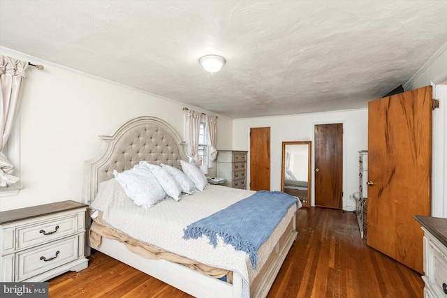 bedroom featuring dark wood-style flooring and ornamental molding