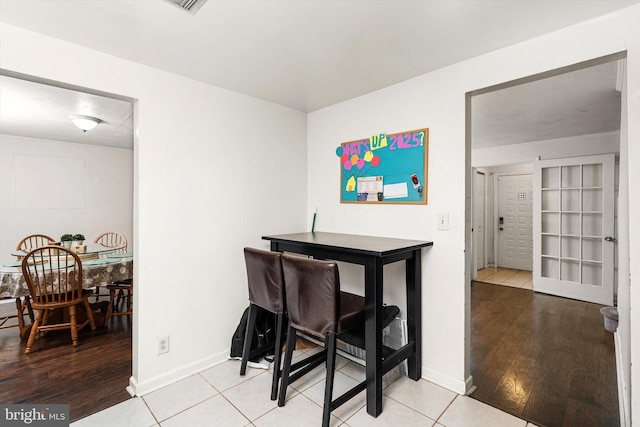 dining area with wood finished floors and baseboards