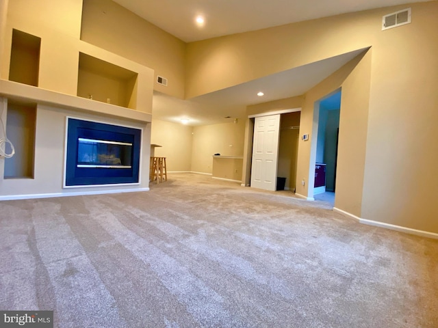 704 Dresher Woods Dr, Dresher, PA 19025 - unfurnished living room featuring carpet floors, a glass covered fireplace, and recessed lighting