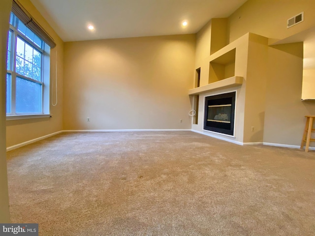 704 Dresher Woods Dr, Dresher, PA 19025 - unfurnished living room featuring carpet floors, a glass covered fireplace, and recessed lighting