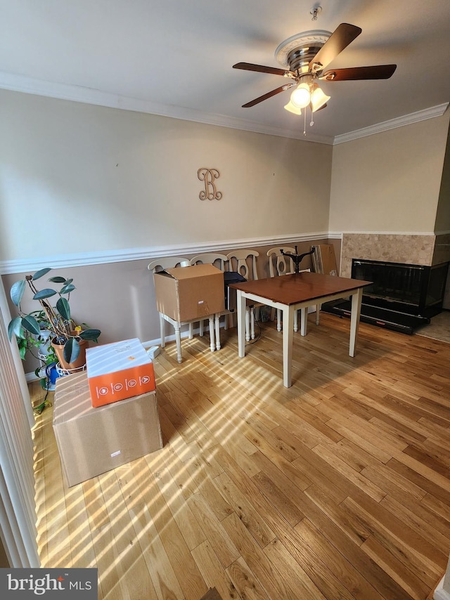 4806 Amberfield Way, Upper Marlboro, MD 20772 - dining area featuring crown molding, ceiling fan, wood finished floors, a fireplace, and a wainscoted wall
