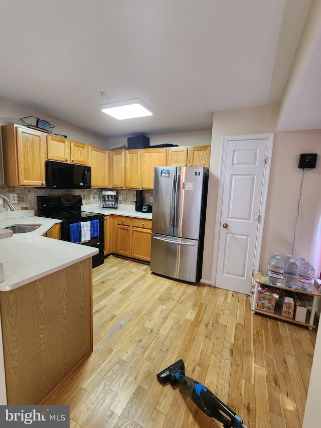 4806 Amberfield Way, Upper Marlboro, MD 20772 - kitchen featuring black appliances, a sink, light wood-style floors, and light countertops