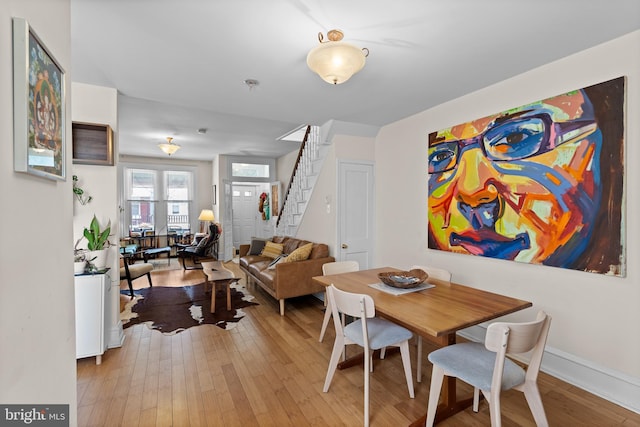 4734 Upland St, Philadelphia, PA 19143 - dining room with light wood finished floors, stairs, and baseboards