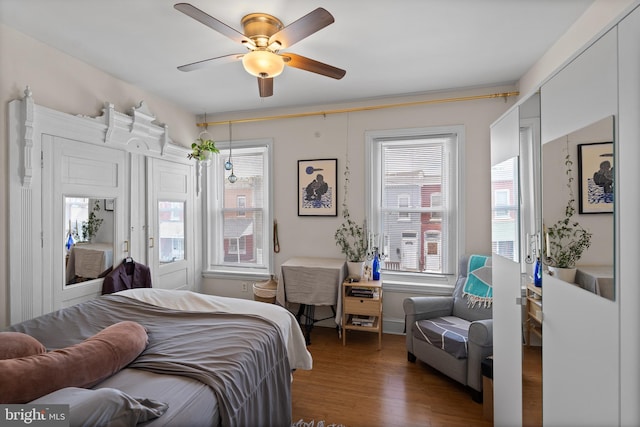4734 Upland St, Philadelphia, PA 19143 - bedroom featuring wood finished floors, multiple windows, and ceiling fan