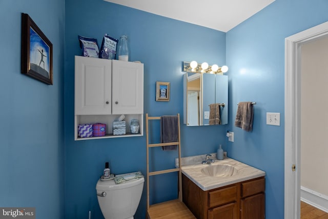 4734 Upland St, Philadelphia, PA 19143 - bathroom featuring vanity, wood finished floors, toilet, and baseboards