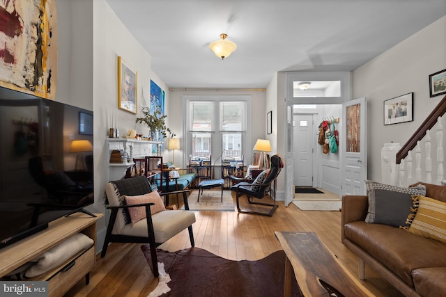 4734 Upland St, Philadelphia, PA 19143 - living room with light wood finished floors and stairway