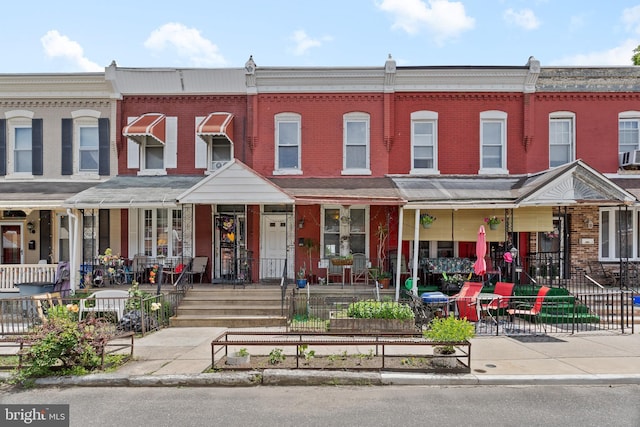 4734 Upland St, Philadelphia, PA 19143 - view of property featuring brick siding and a porch