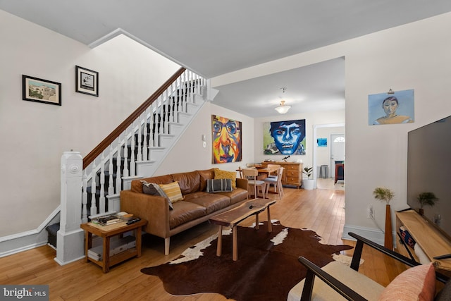 4734 Upland St, Philadelphia, PA 19143 - living room with light wood-style flooring, stairs, and baseboards
