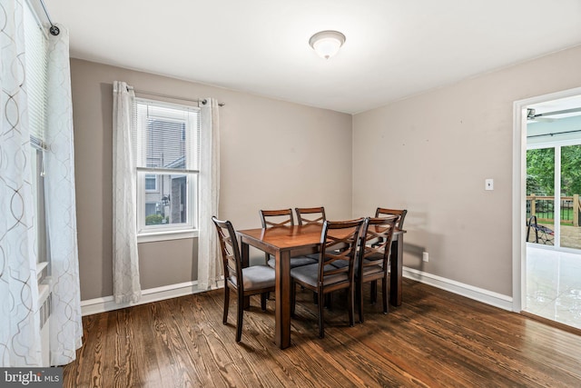 dining area with dark wood-style flooring and baseboards